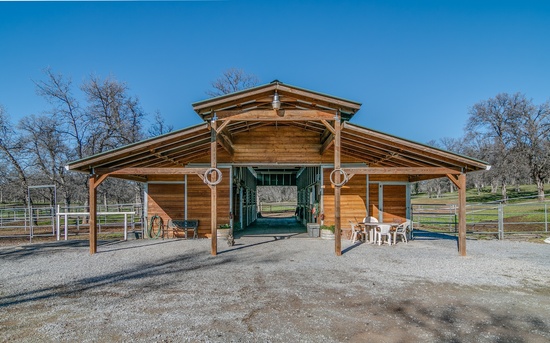 We have a 6 stall pine barn with a variety of paddocks . From 12'x24' paddocks to stalls with pasture. Our barn has a grain area, sink, fridge and a private tack room. 